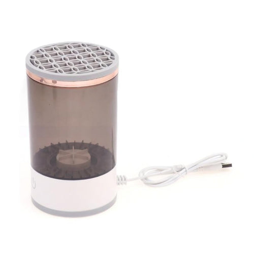 Small cylindrical device with a grid top and power cord on a white background